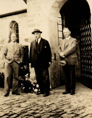 Gari Melchers (center) and studio architect, John Donaldson (left) in front of studio gate, ca. 1920s.