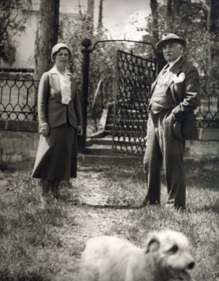 Gari and Corinne Melchers with dog in front of Belmont's lower gate, ca. 1920s.